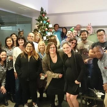 Zoosk - Gathered around the holiday tree, picking out gifts to give to families in need.