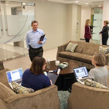 Next Century Corporation - Next Century CEO John McBeth mingles with the UX team during their morning meeting.