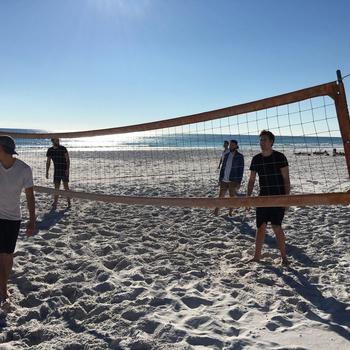 Unsplash - Some of our team playing Volleyball at one of our summer retreats.