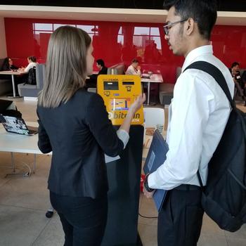 localcoin - Kayla demoing one of our machines to an interested candidate