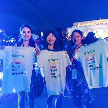 Google - Three Googlers holding up shirts that say "Create, Design, Code, Build for everyone"