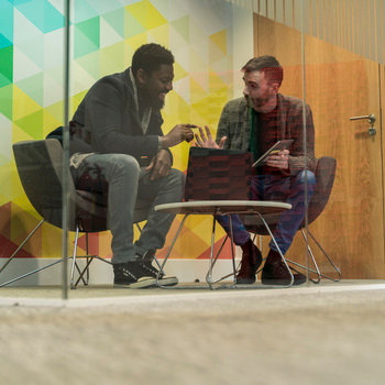 VMware - Two men having a discussion in a conference room 