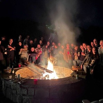 Extend Enterprises - Team gathering around a huge fire pit