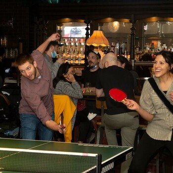 Locusview - Team members play ping pong at a company-sponsored happy hour.