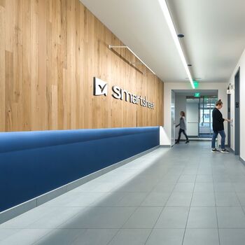Smartsheet - The lobby of the Smartsheet Bellevue office building with a wooden wall.